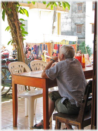 Man at cafe table.