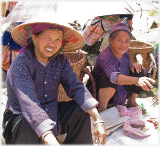 Two venders in traditional hats.