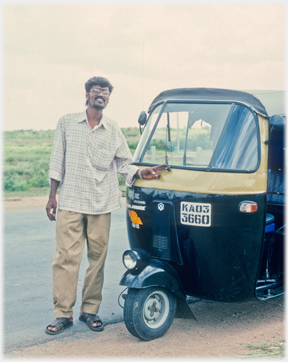 Driver standing beside his auto