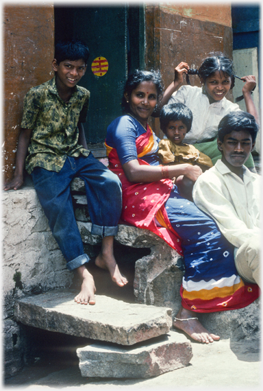 Family on steps at door.