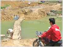 Motorbike waiting by pontoon bridge.