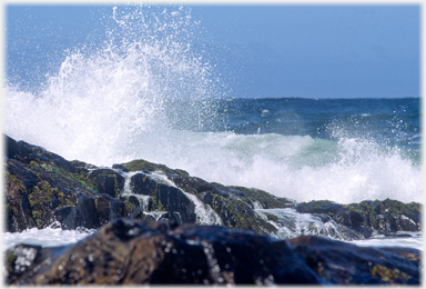 Breaker over rocks.