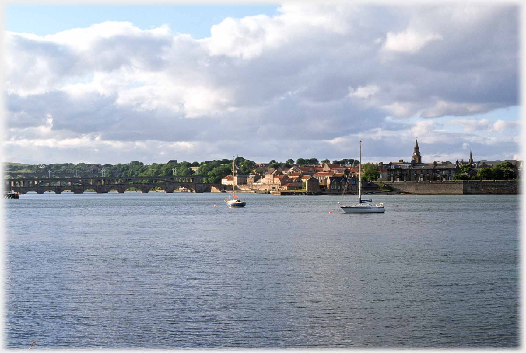 Two bridges and town across river.