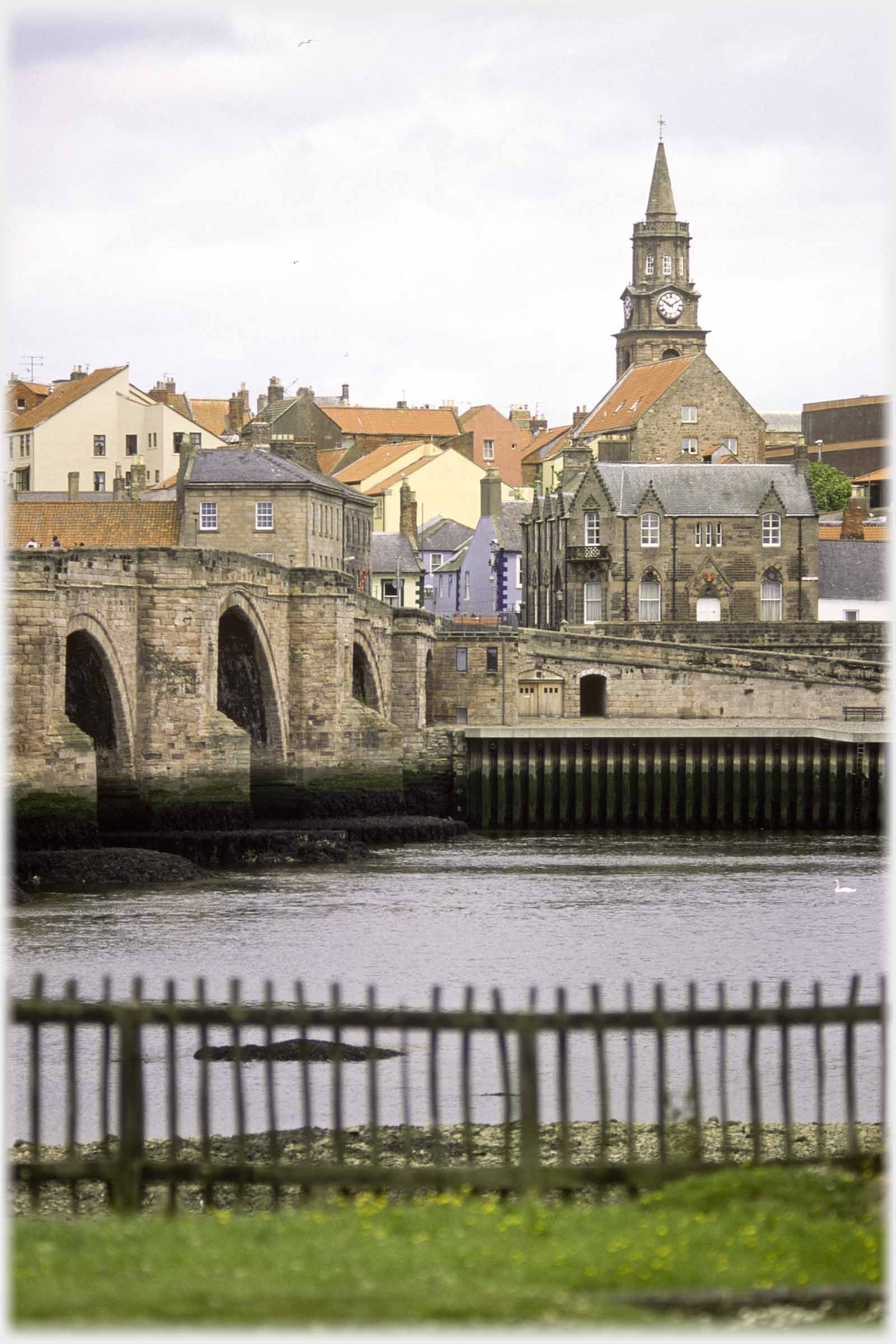 River with bridge to side and buildings opposite.