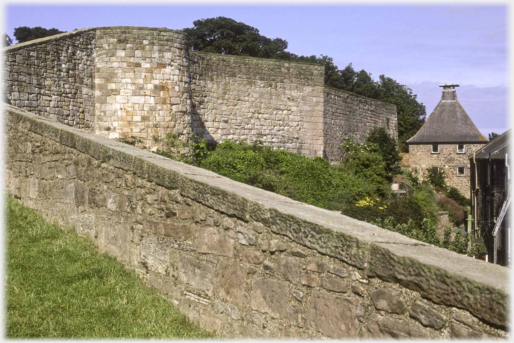 Folding town wall with cupola on building.