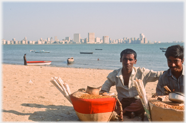 Two men selling nuts.