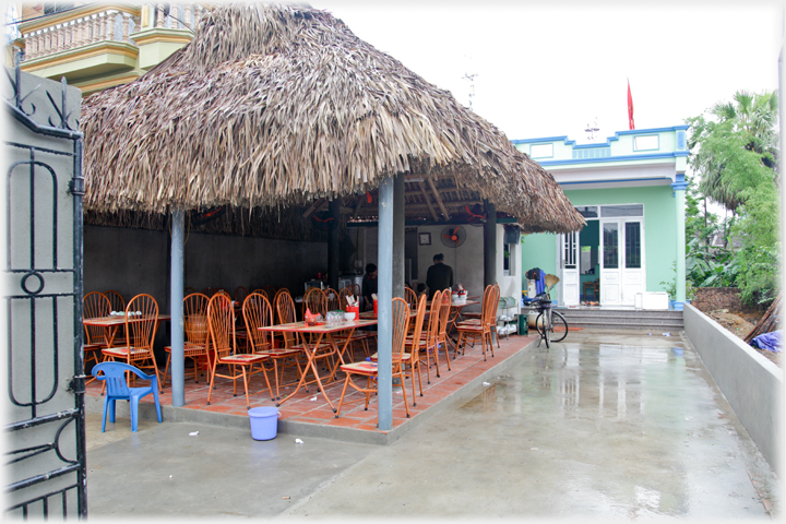 The newly thatched cafe in the rain.