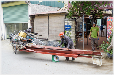 Metal gutters being weighed by scrap merchant.