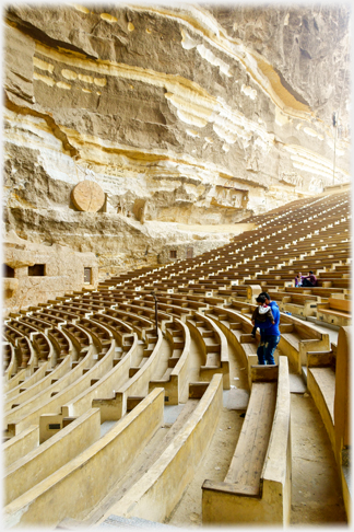 The rock wall of the cave.