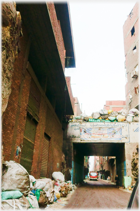 Road and bridge piled with rubbish.