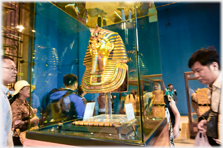Tut mask with visitors.