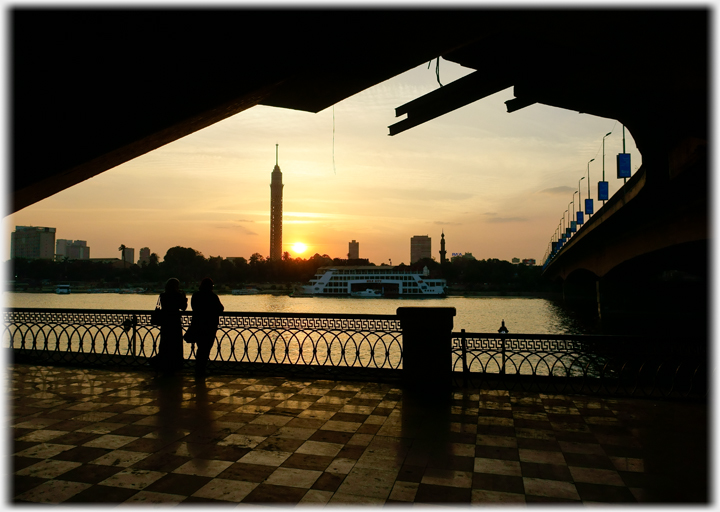 Sunset over Nile under bridge.