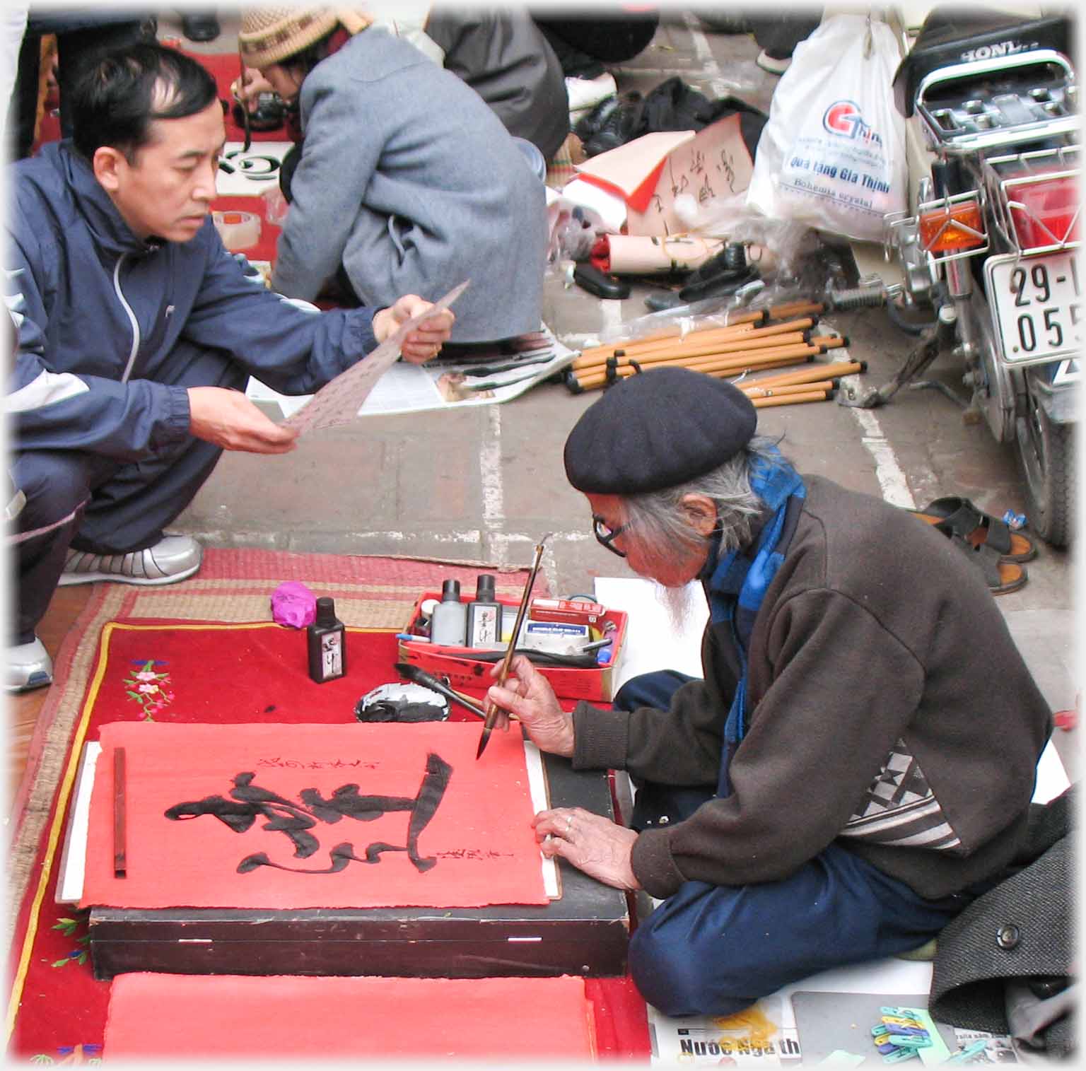 Bereted man writes while other man holds paper.