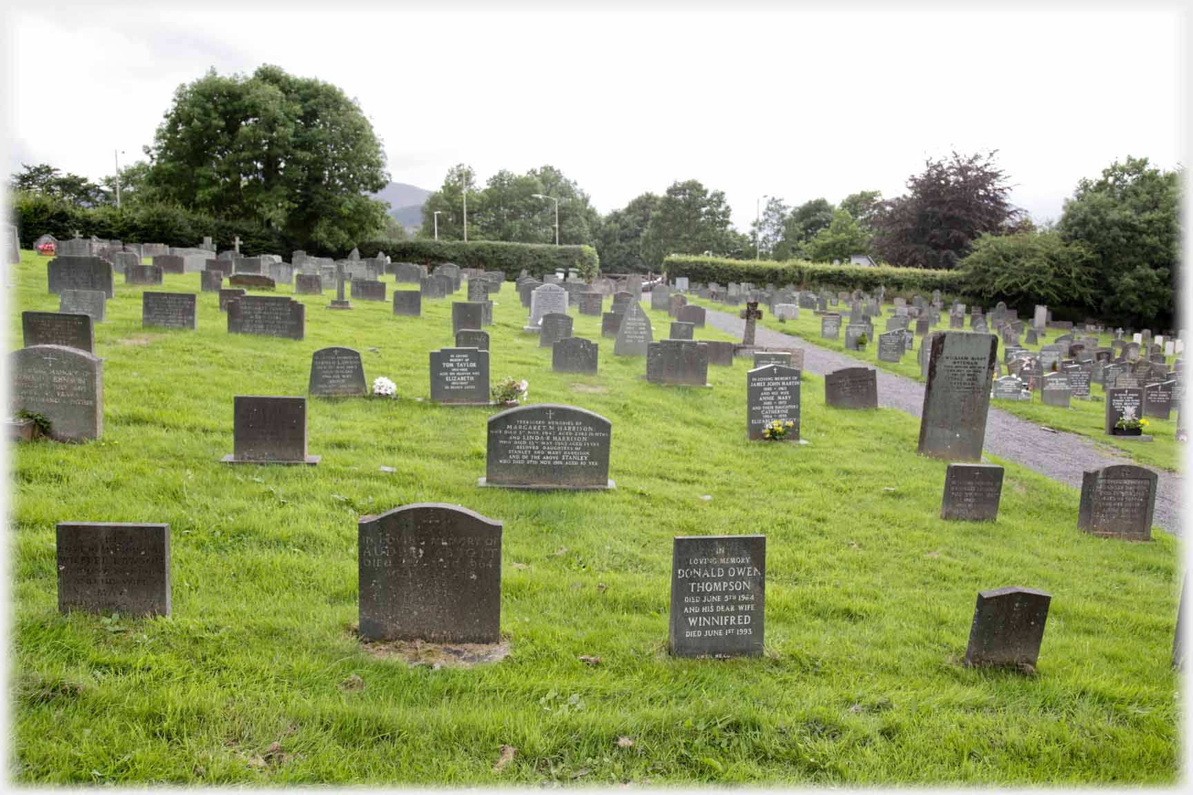 Graveyard, inscription of central front stone to Donald and Winnifred Thompson.