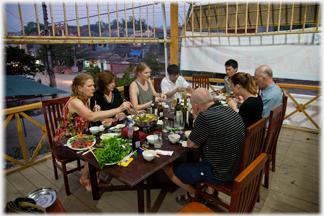 Group of westerners eating on hotel roof.