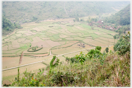 A valley floor with a rich patterning of fields.