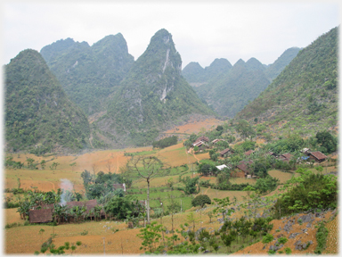 Pointed karst and village with short vegetation.