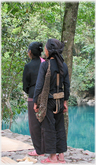 The backs of two women, one with large jack knief in her belt.