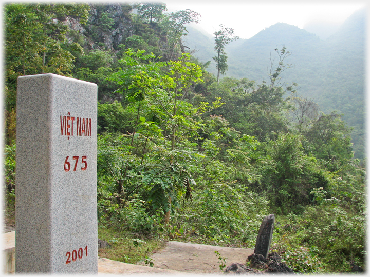 Border marker 675 from Vietnamese side with jungle background.