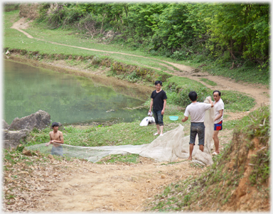 Detail of pictue below showing four fishermen preparing their nets.