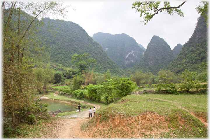 River in karst valley with fishermen.