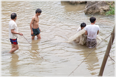 Bundled net being lifted out of the water.