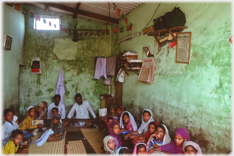 The school room with teachers and pupils.