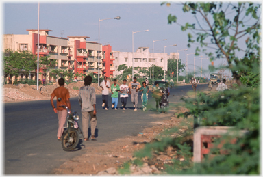 Joggers on a road near beach.