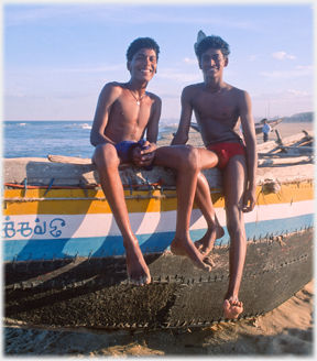 Two students sitting on boat.