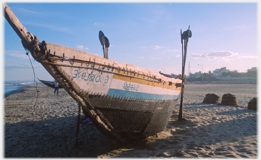 Boat with sewn panels and the words 'God is Love' backwards.