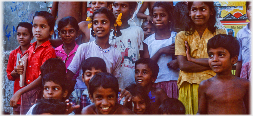 Children being instructed to line up to be photographed.