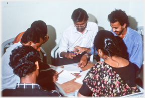 Six team members working around a table.