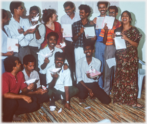 The team standing in a group holding attestations of their day's training.