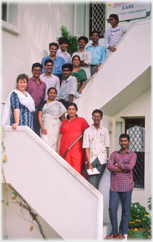 The ARFI team of 14 people posing on the turning steps up to the first floor.