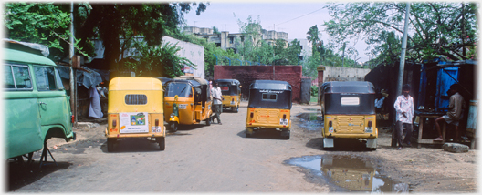 Five autos near a tea shop.