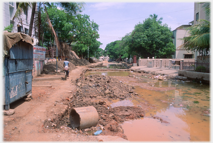 Path beside where a road has been removed and is now full of water.