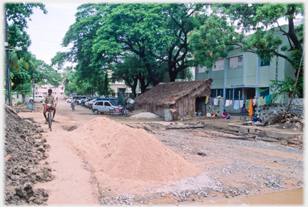 Another view of the excavated road, with the intact road beyond.