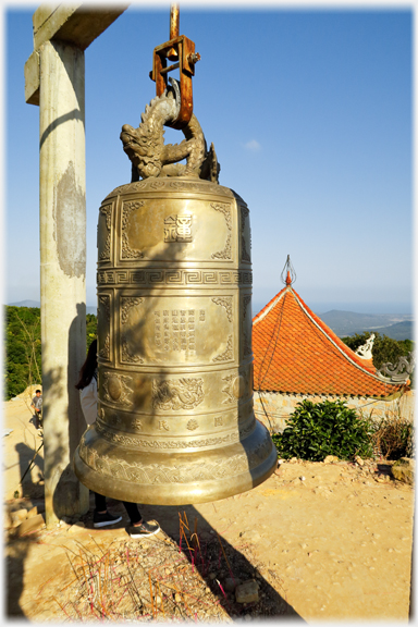 The bell with the tiny pagoda beyond.