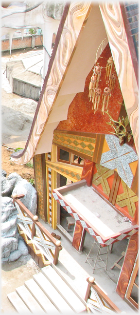 The triangular gable canopy and associated rectaliniar furnishings.