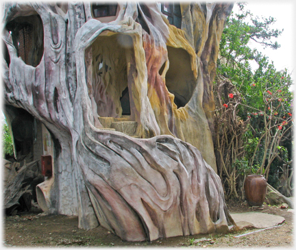 Steps up to entrance from the ground into an apparent 'tree'.