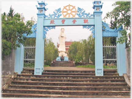 Steps leading to portal and Buddha figure beyond.