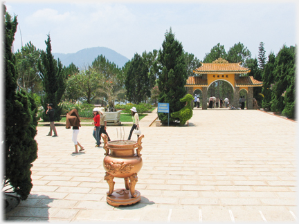 Open courtyard with figures covering their heads.