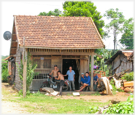 Group of men at the front of a house.