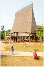 The 90 foot high Kon Tum house with two people.