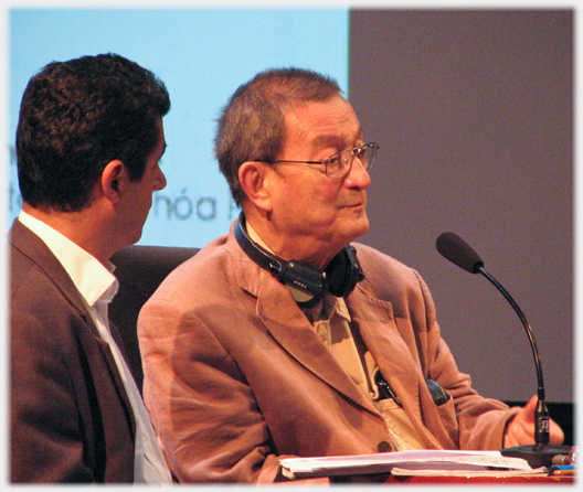 George Condominas with microphone in his 80s in Ha Noi.