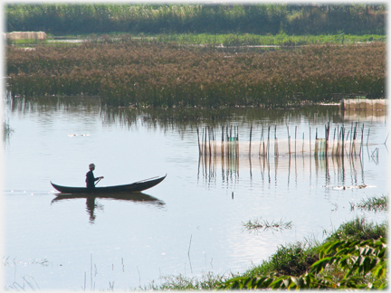 Fisherman in canoe.