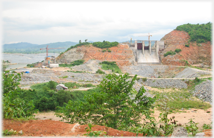 Narrow vertical dam under construction.