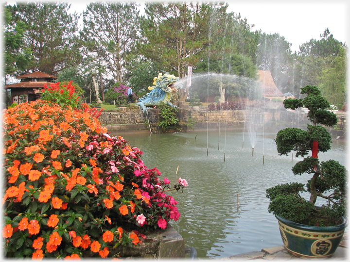 Pool with fountains, bonsai, dragons and imatiens.