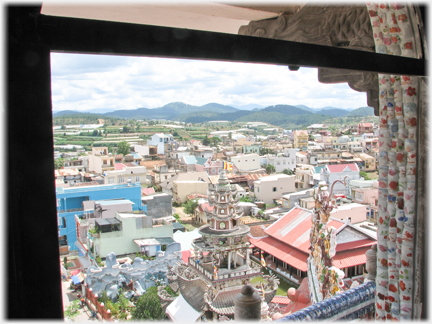 View out of a window in the tower of rooftops and the entrance tower.