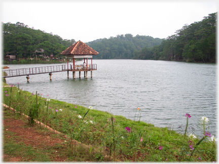 Small pavilion in the lake accessed by bridge.